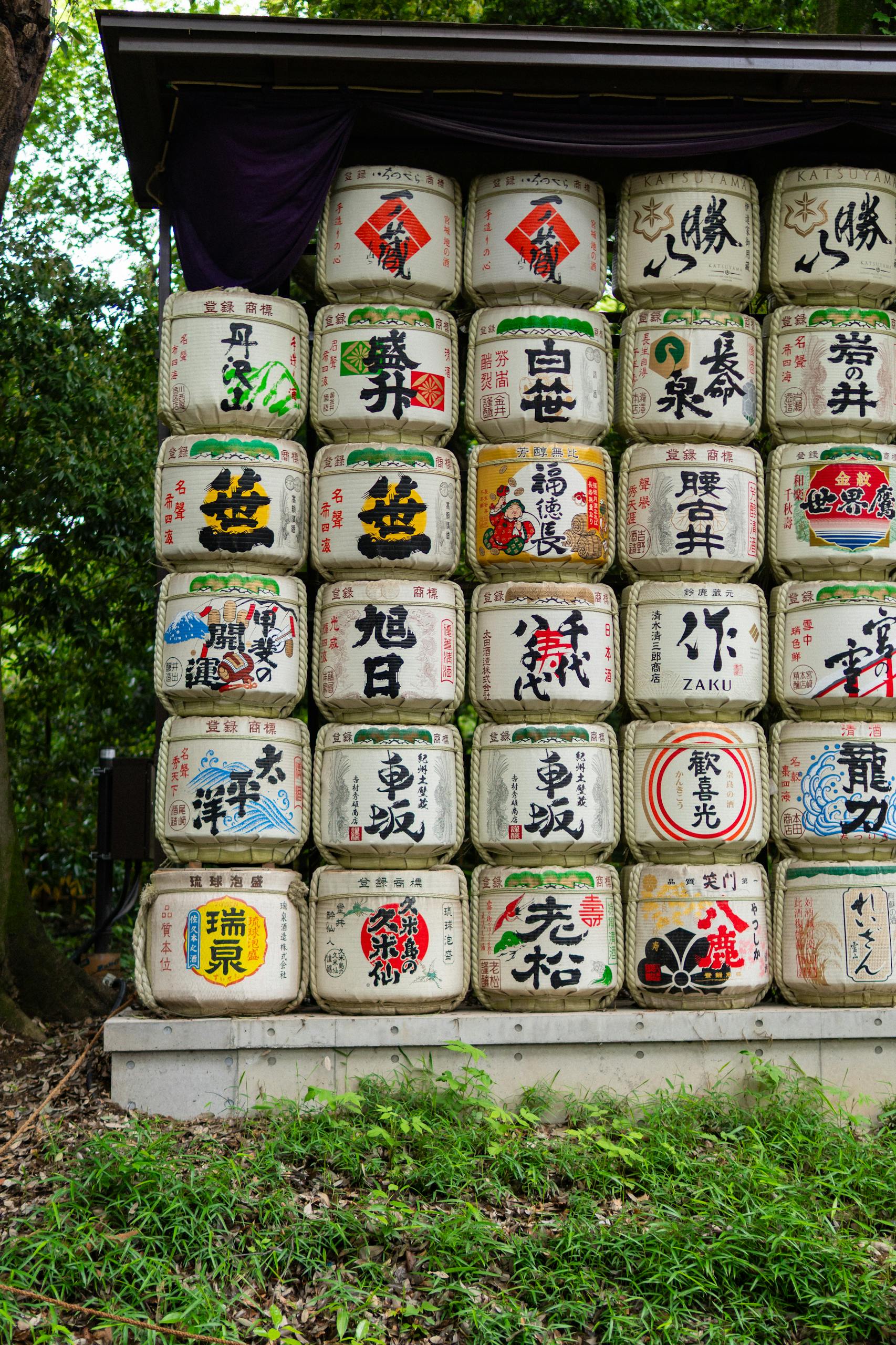 Sake barrels stacked in a traditional Japanese garden, showcasing cultural aesthetics.