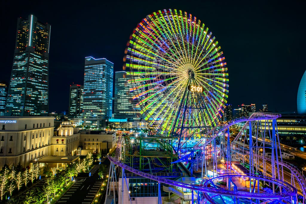 Vibrant night view of Yokohama's Cosmo Clock 21 Ferris wheel in Japan's urban cityscape.