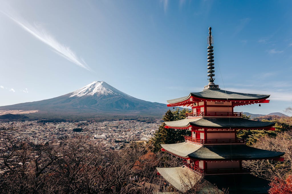 A breathtaking view of Mount Fuji alongside the iconic Chureito Pagoda under a clear sky.