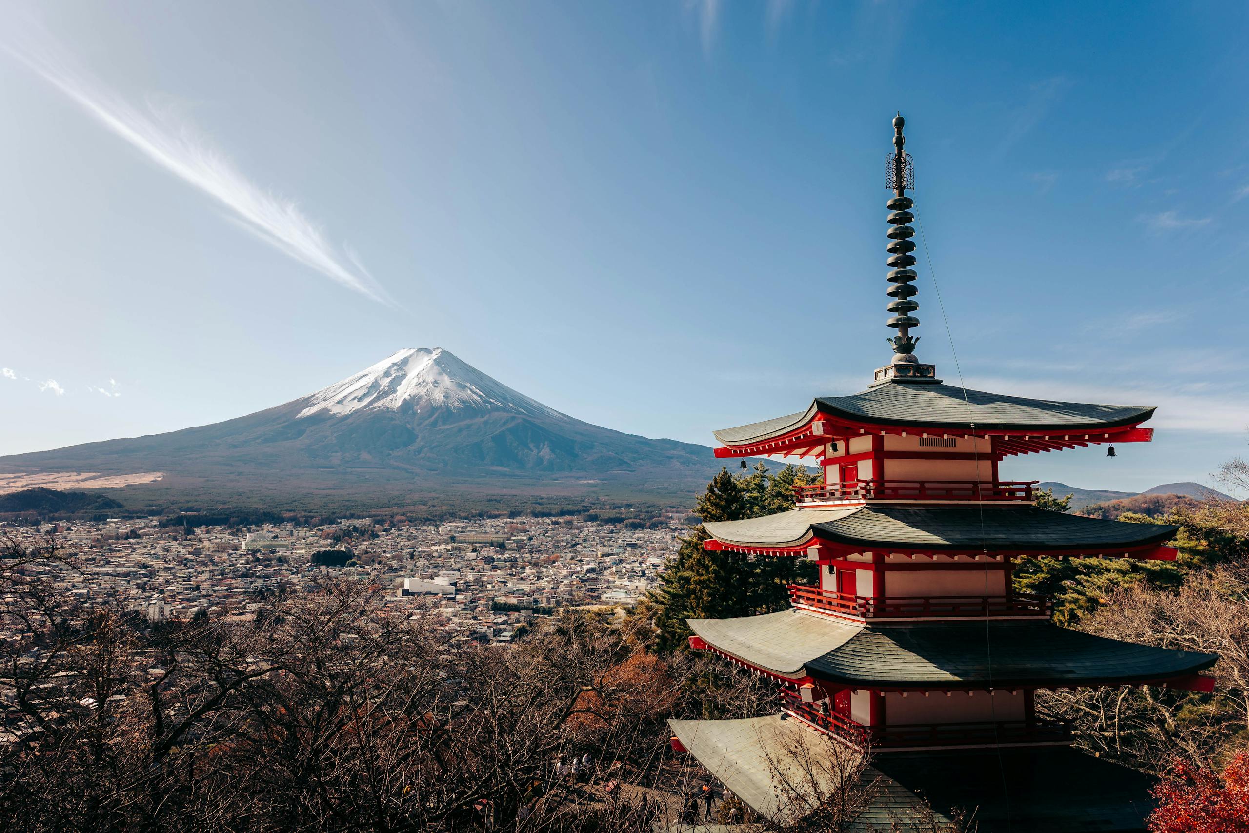 A breathtaking view of Mount Fuji alongside the iconic Chureito Pagoda under a clear sky.
