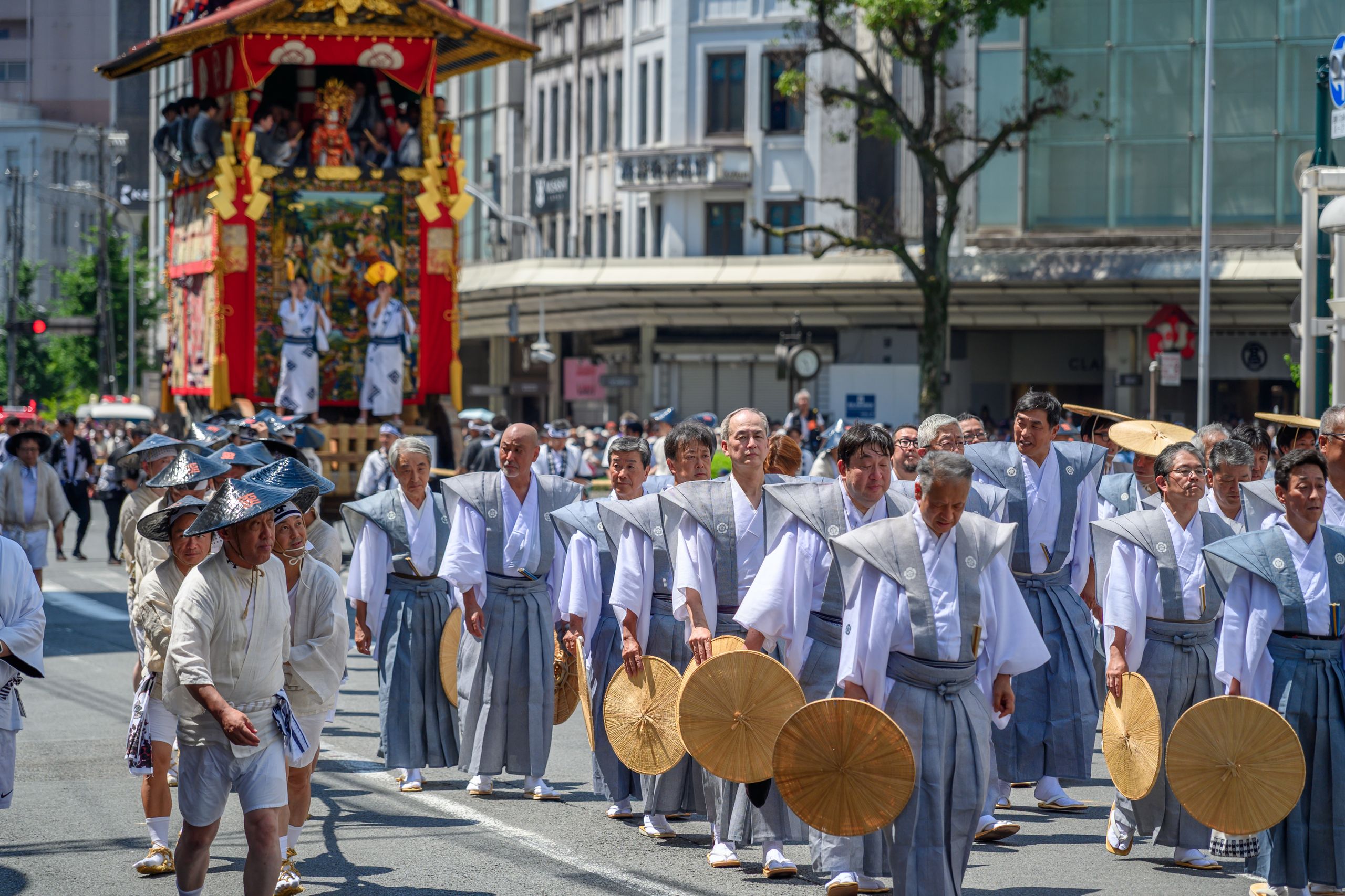 Participants in traditional attire marching in a vibrant cultural parade in Kyoto, Japan.